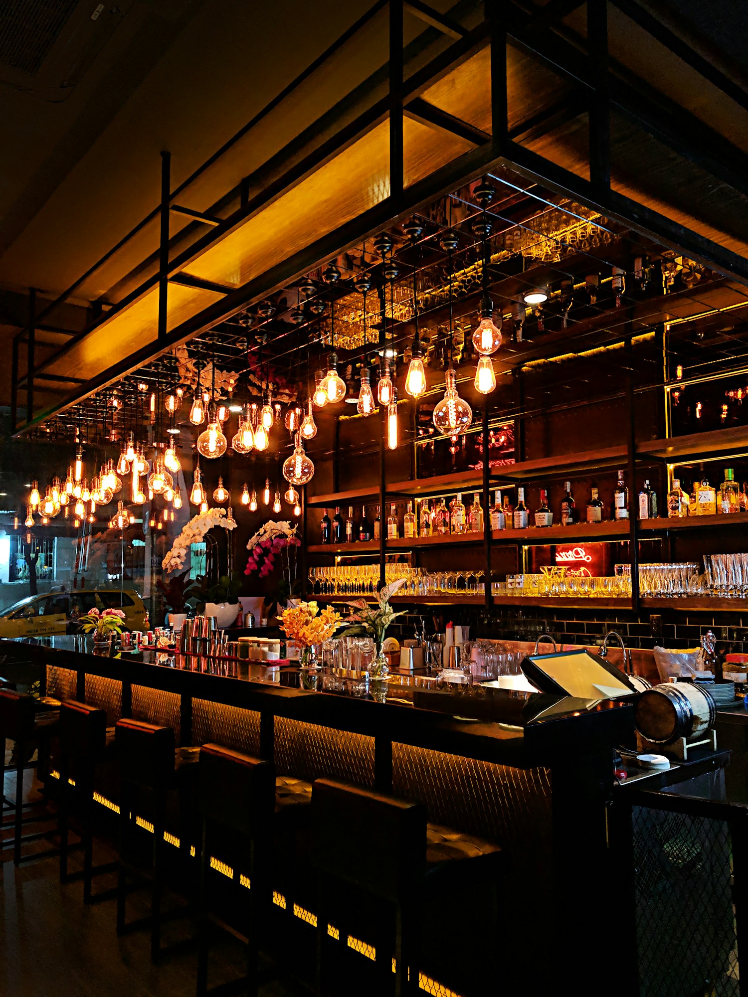 A warmly lit bar stocked with spirits, ales and lagers